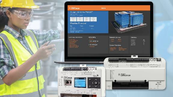  A person in safety vest and helmet standing next to a computer