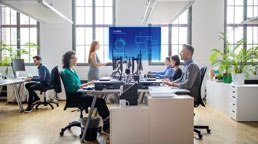 A group of people sitting at desks in an office