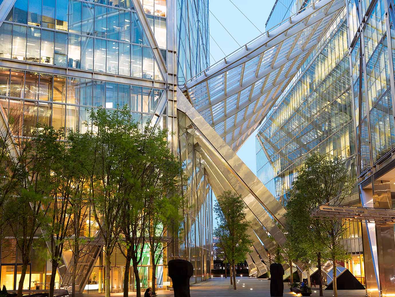 A building with glass walls and trees