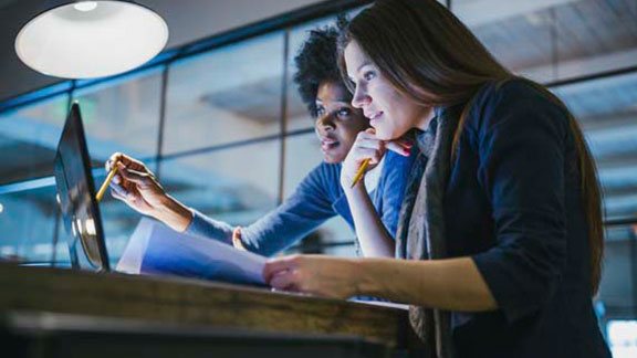two women laptop in office